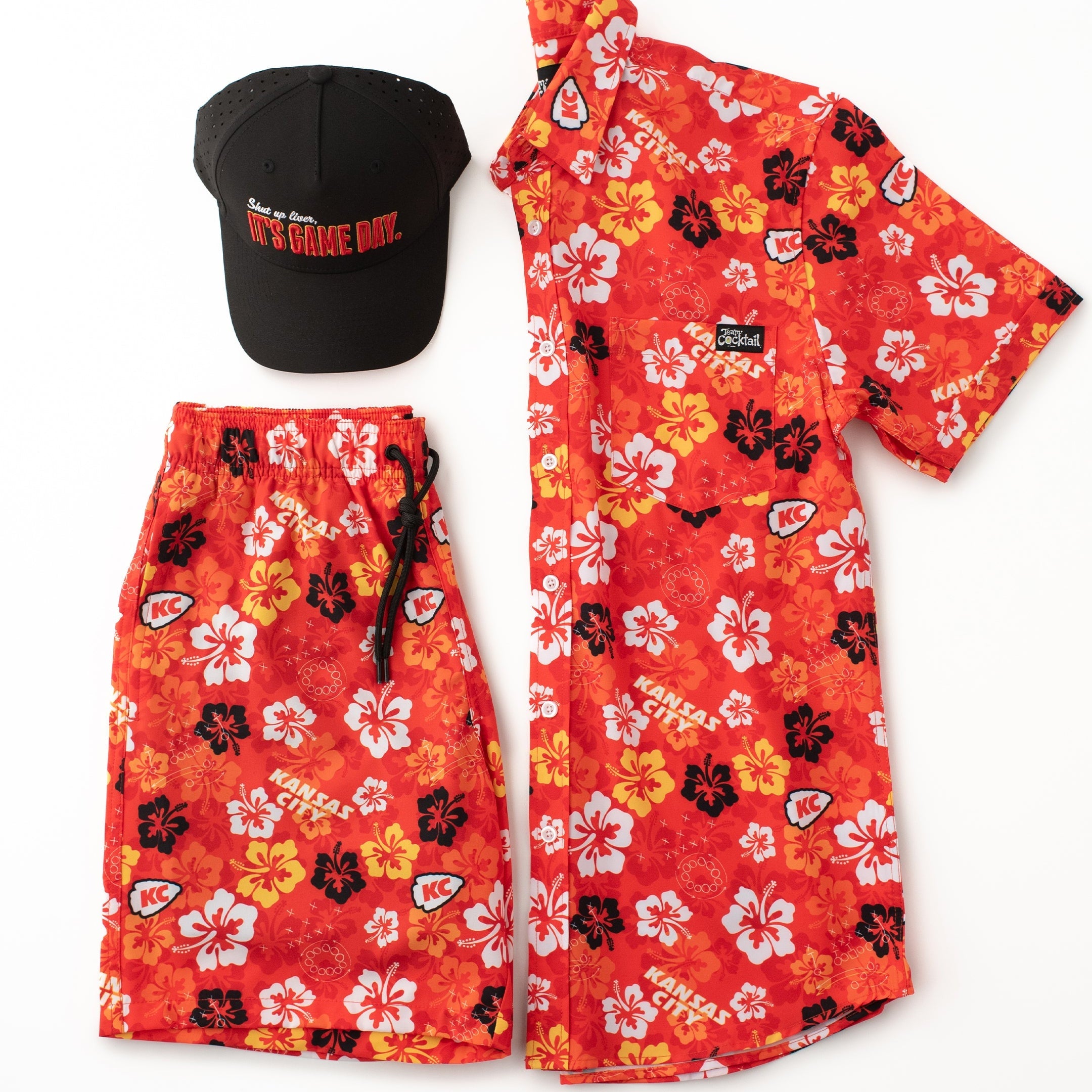 Red floral shirt and shorts set with a black cap on a white background