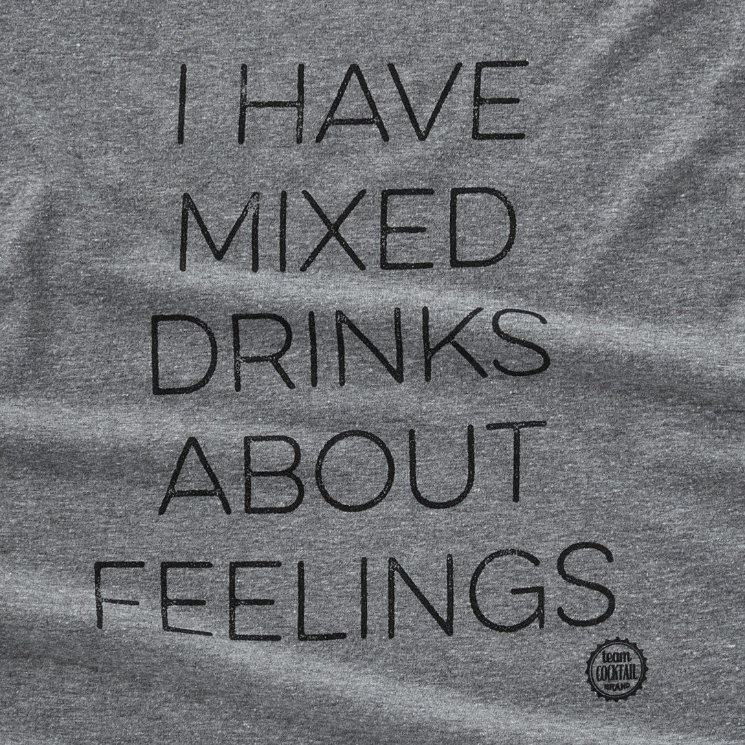 Gray t-shirt with black text 'I HAVE MIXED DRINKS ABOUT FEELINGS' on a plain background