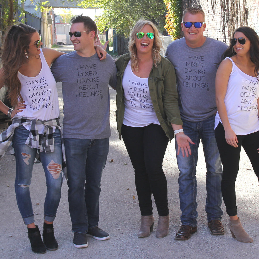 Five people standing together wearing matching t-shirts with humorous text.