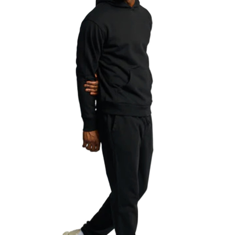 Person wearing a black hoodie and black pants on a white background