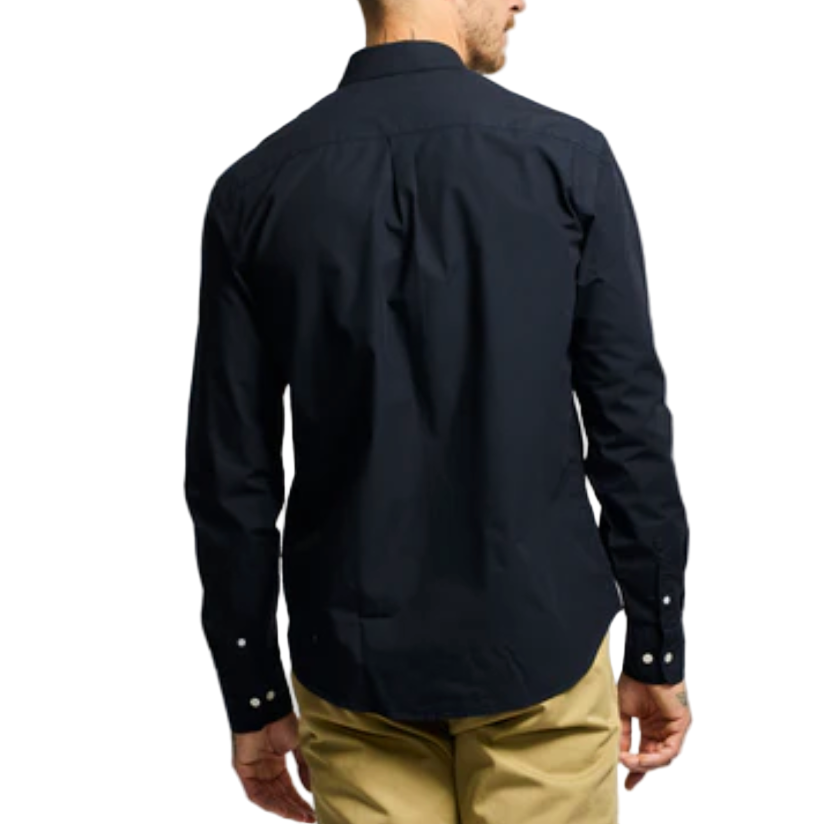 Man wearing a black shirt and beige pants on a white background