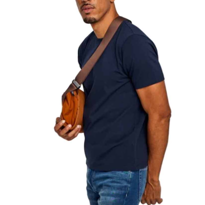 Man holding a brown leather bag against a white background
