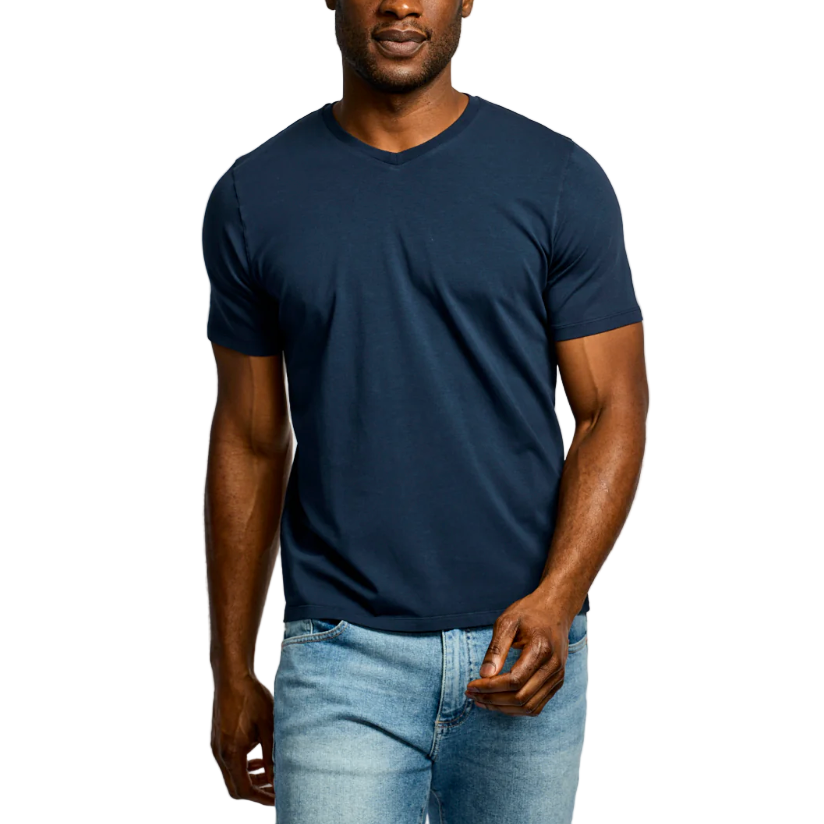 Man wearing a navy blue t-shirt and light blue jeans on a white background