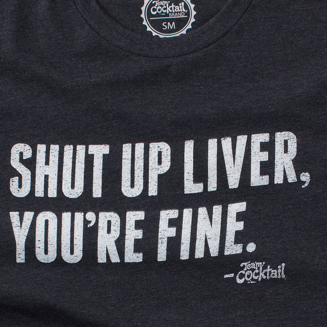Black t-shirt with white text 'SHUT UP LIVER, YOU'RE FINE.' and brand logo on a dark background