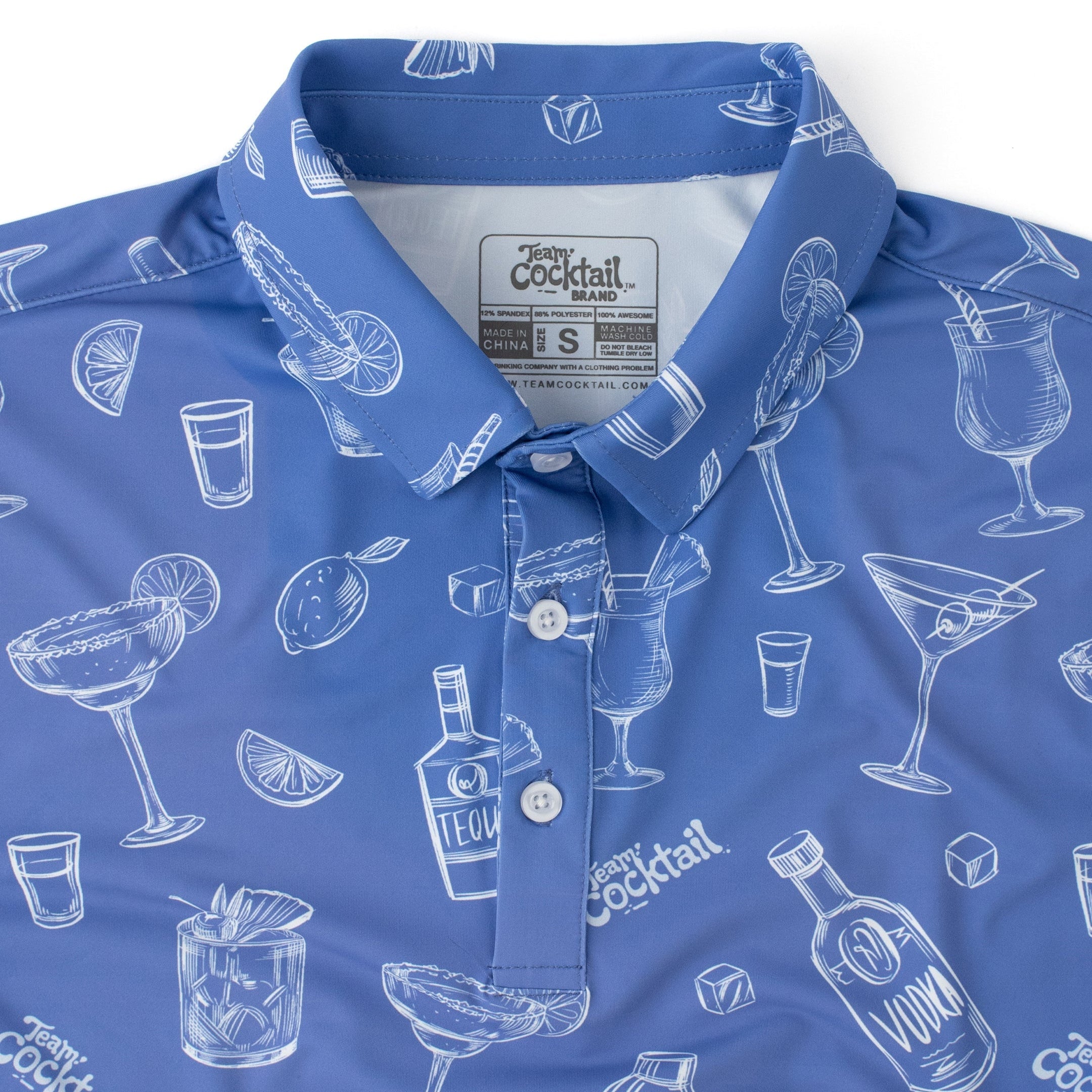 Blue polo shirt with white cocktail-themed pattern on a white background