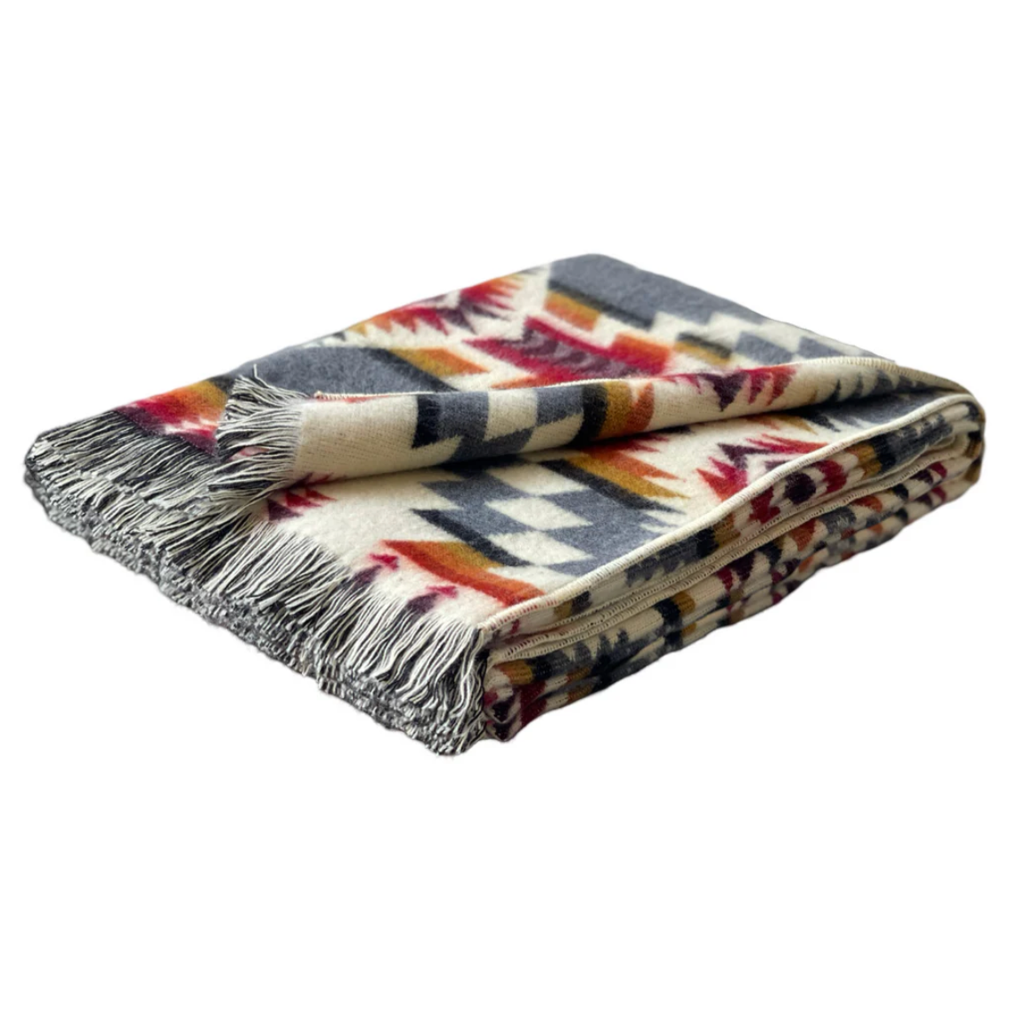 Patterned blanket with fringes on a white background