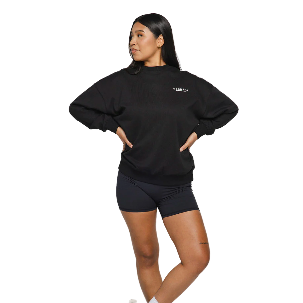 Person wearing a black sweatshirt and shorts on a white background