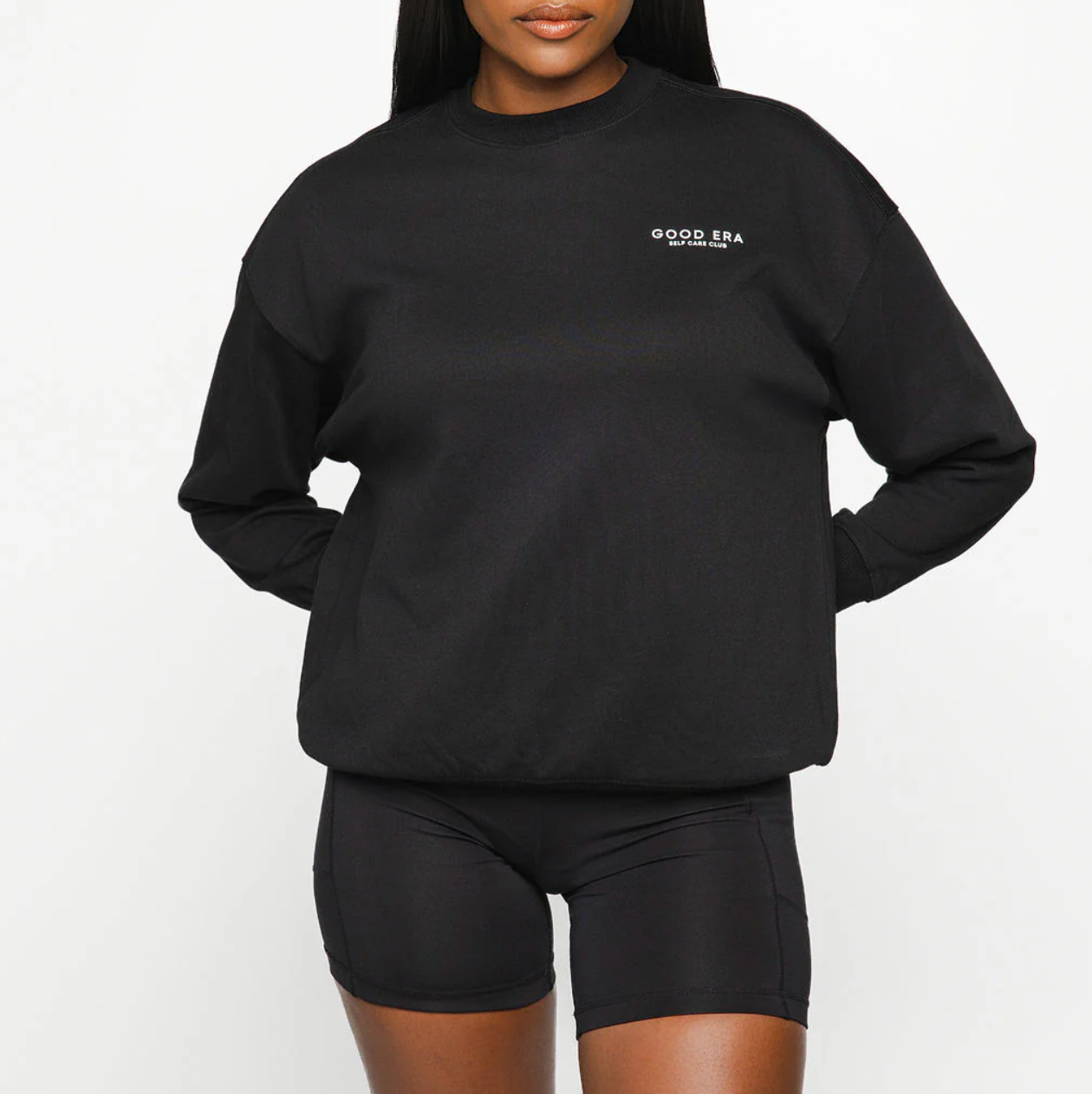 Person wearing a black sweatshirt with 'GOOD ERA' logo on a white background
