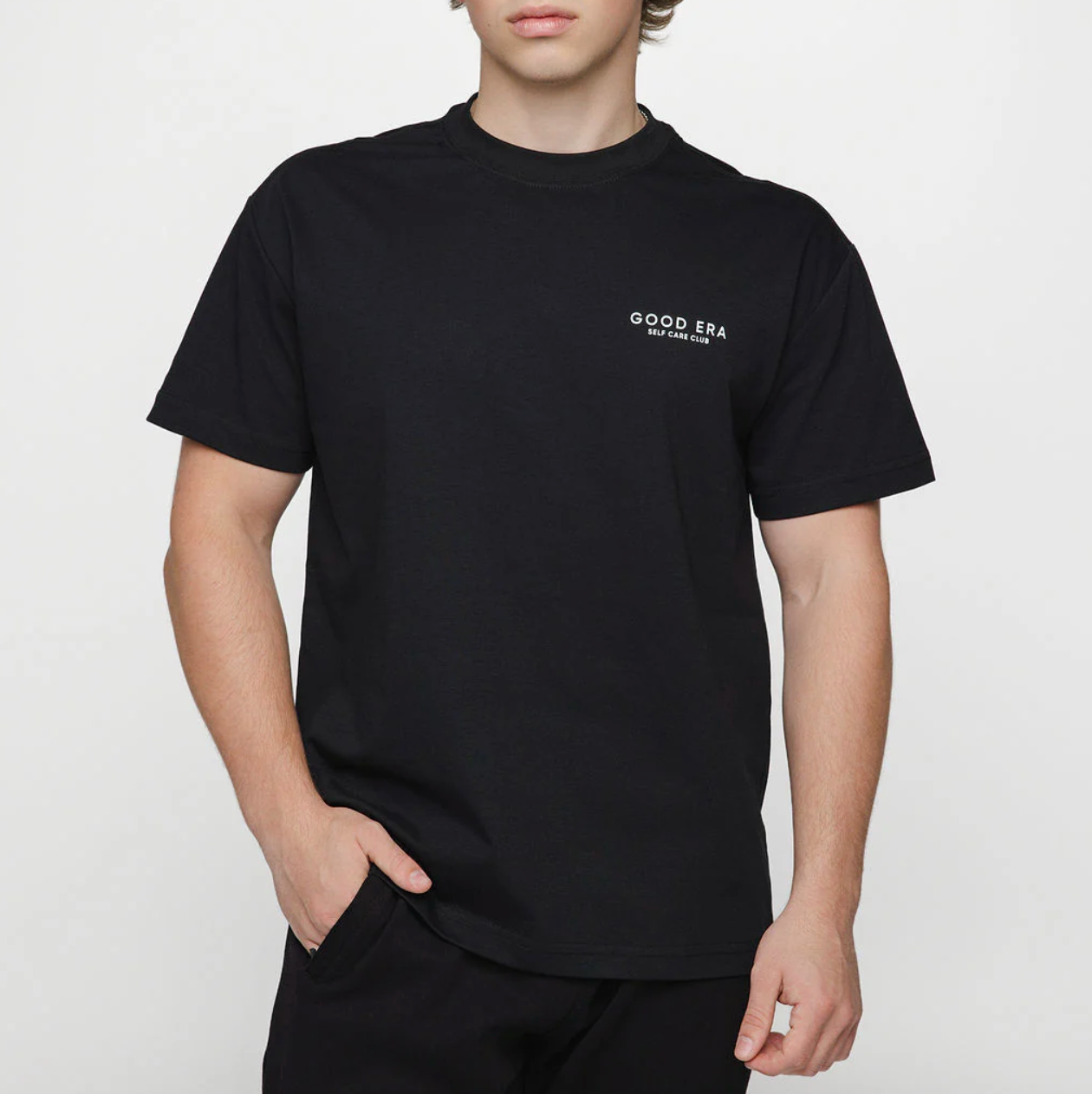 Person wearing a black t-shirt with 'Good Era' logo on a white background