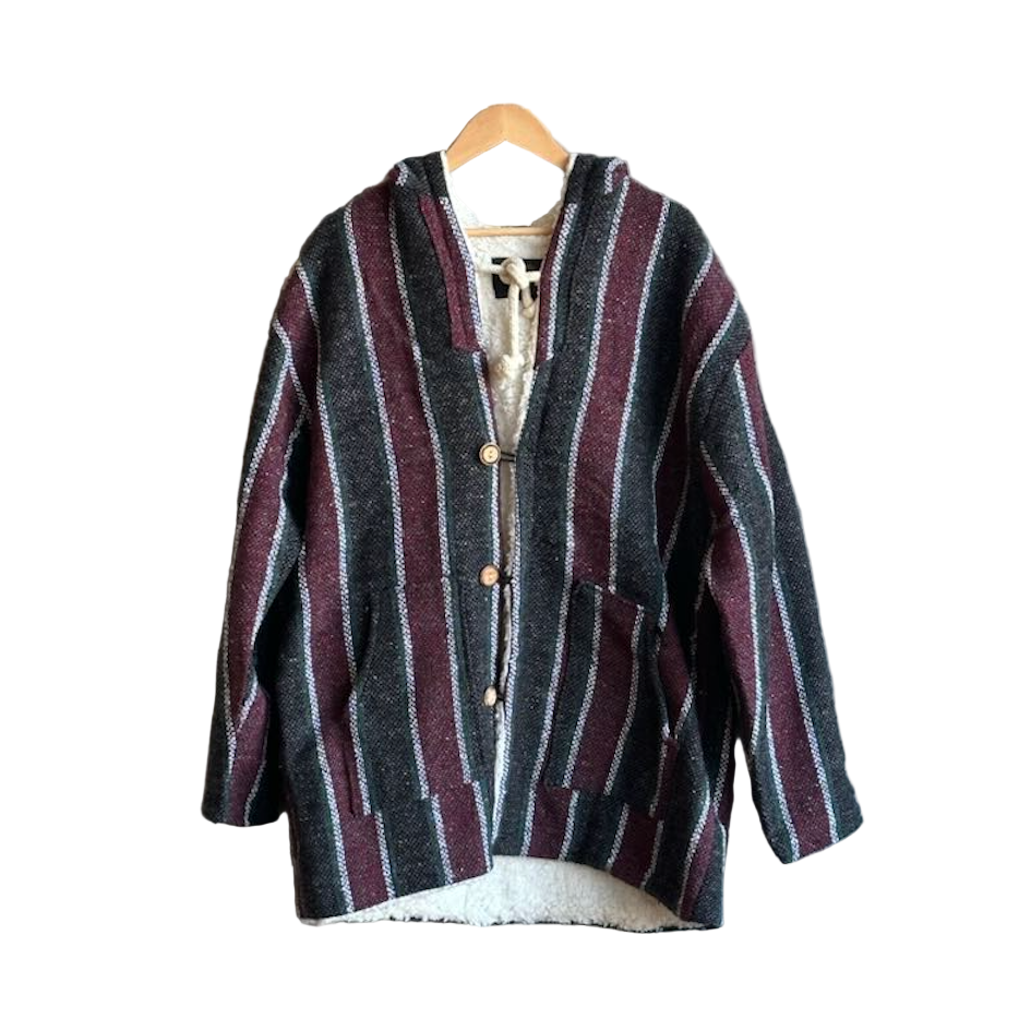 Striped cardigan on a hanger against a white background