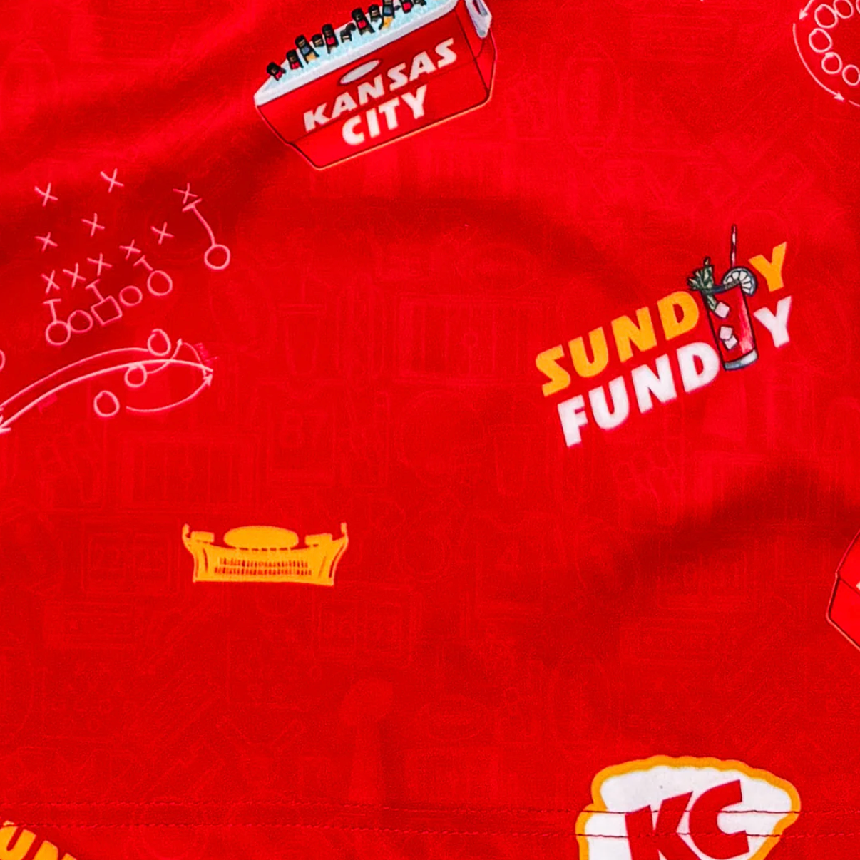 Red fabric with various logos and text, including 'Kansas City' and 'Sundy Fundy'.