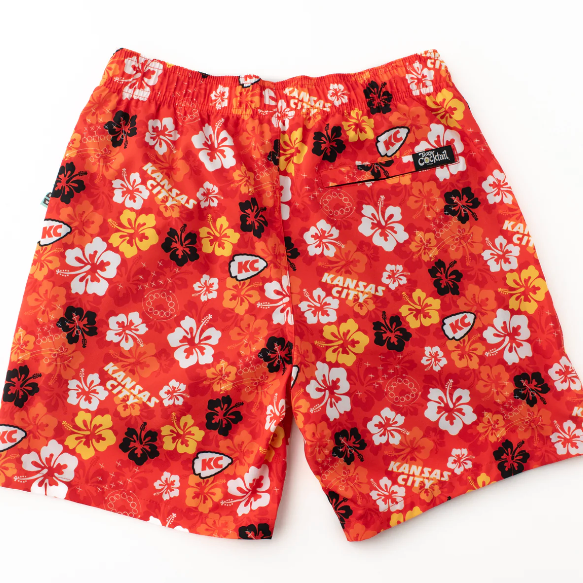 Red shorts with floral and 'Kansas City' patterns on a white background