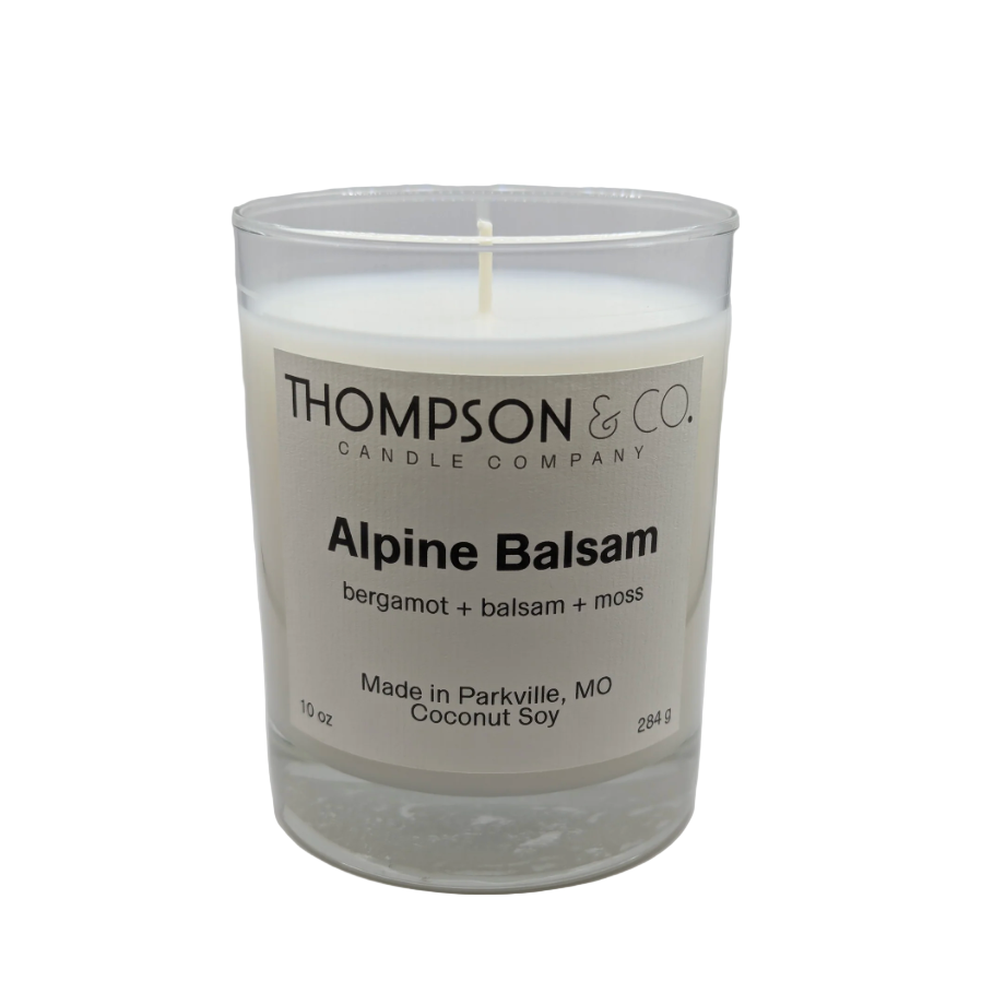 Candle with 'Thompson & Co.' label on a white background