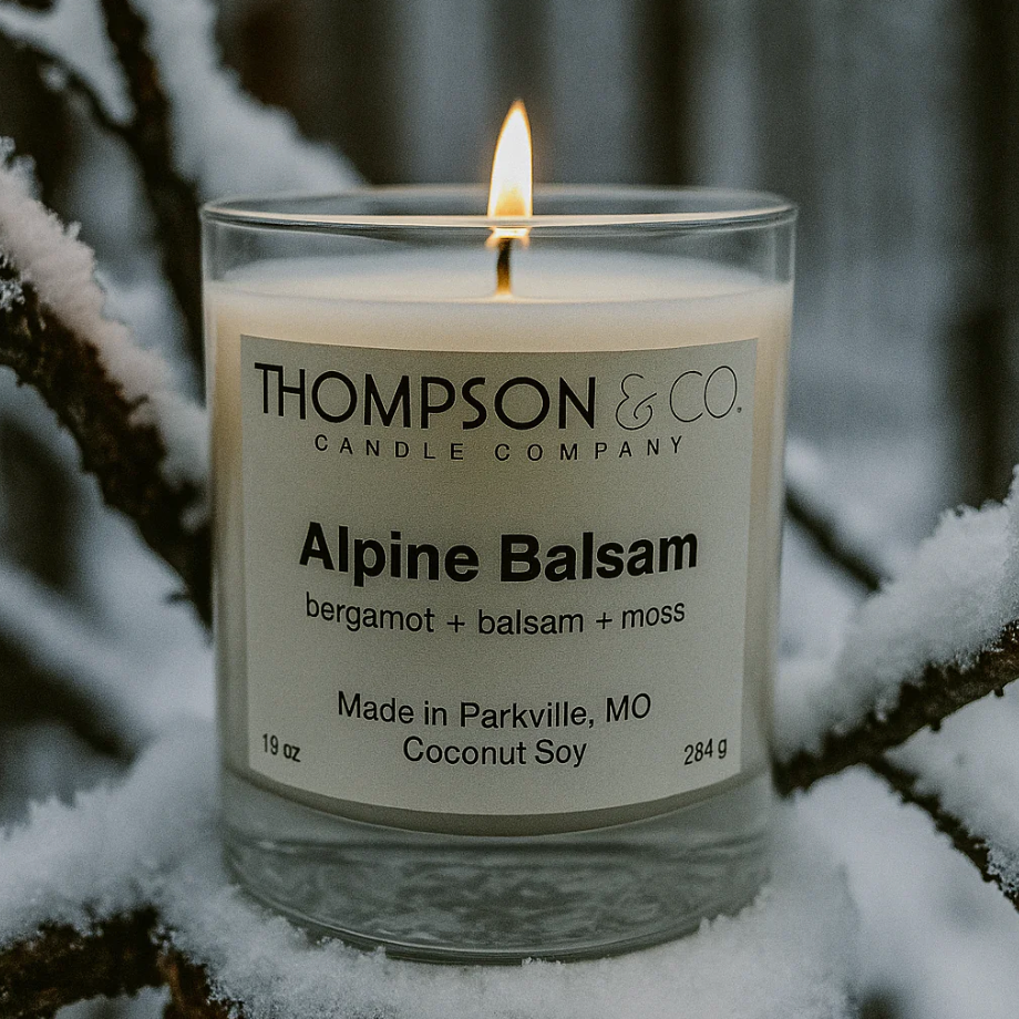 Candle from Thompson & Co. Candle Company on a snowy branch