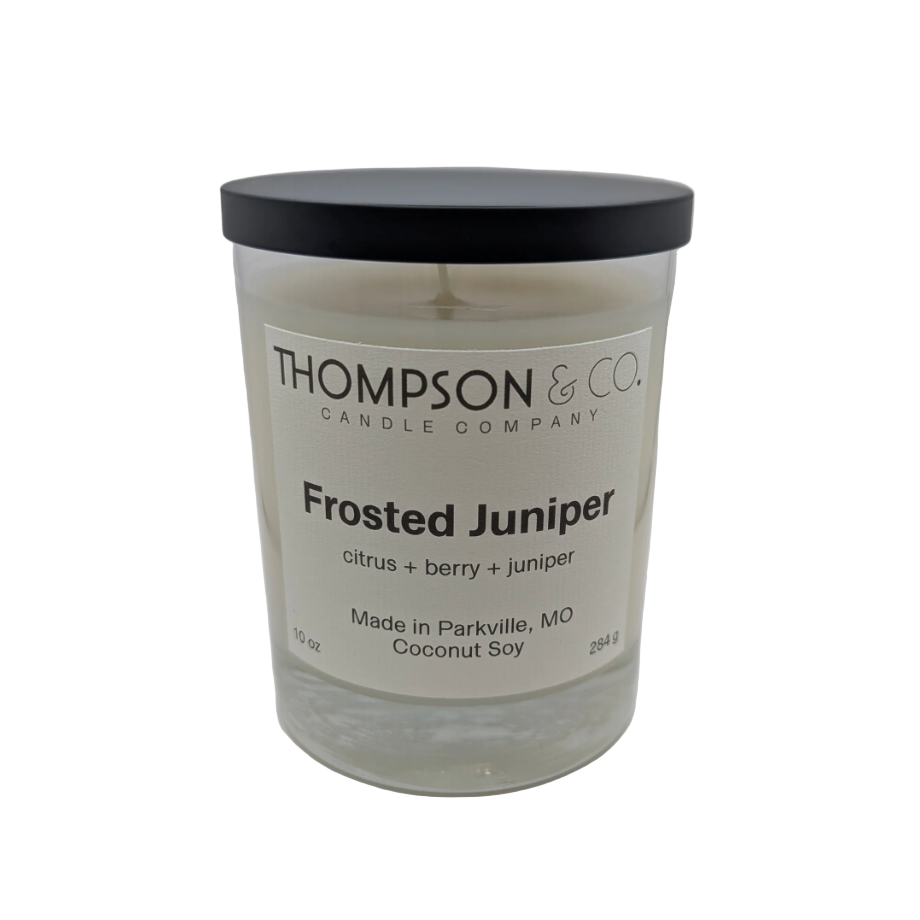 Thompson & Co. Frosted Juniper candle with a black lid on a white background