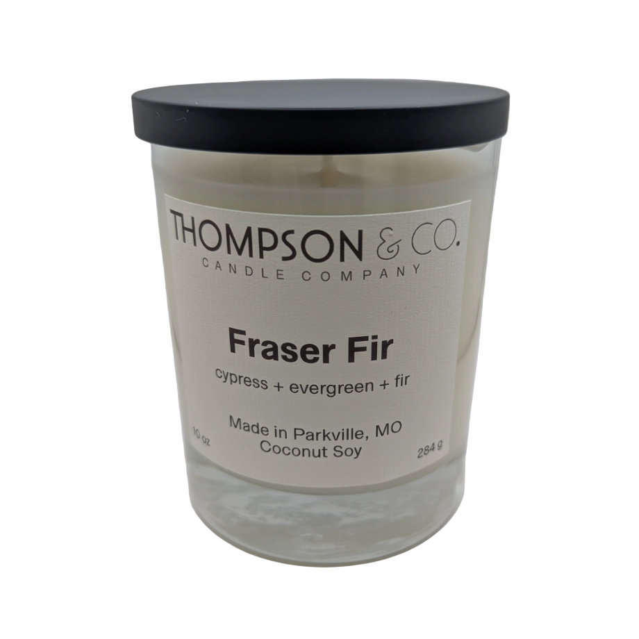 Candle with 'Thompson & Co.' label on a white background