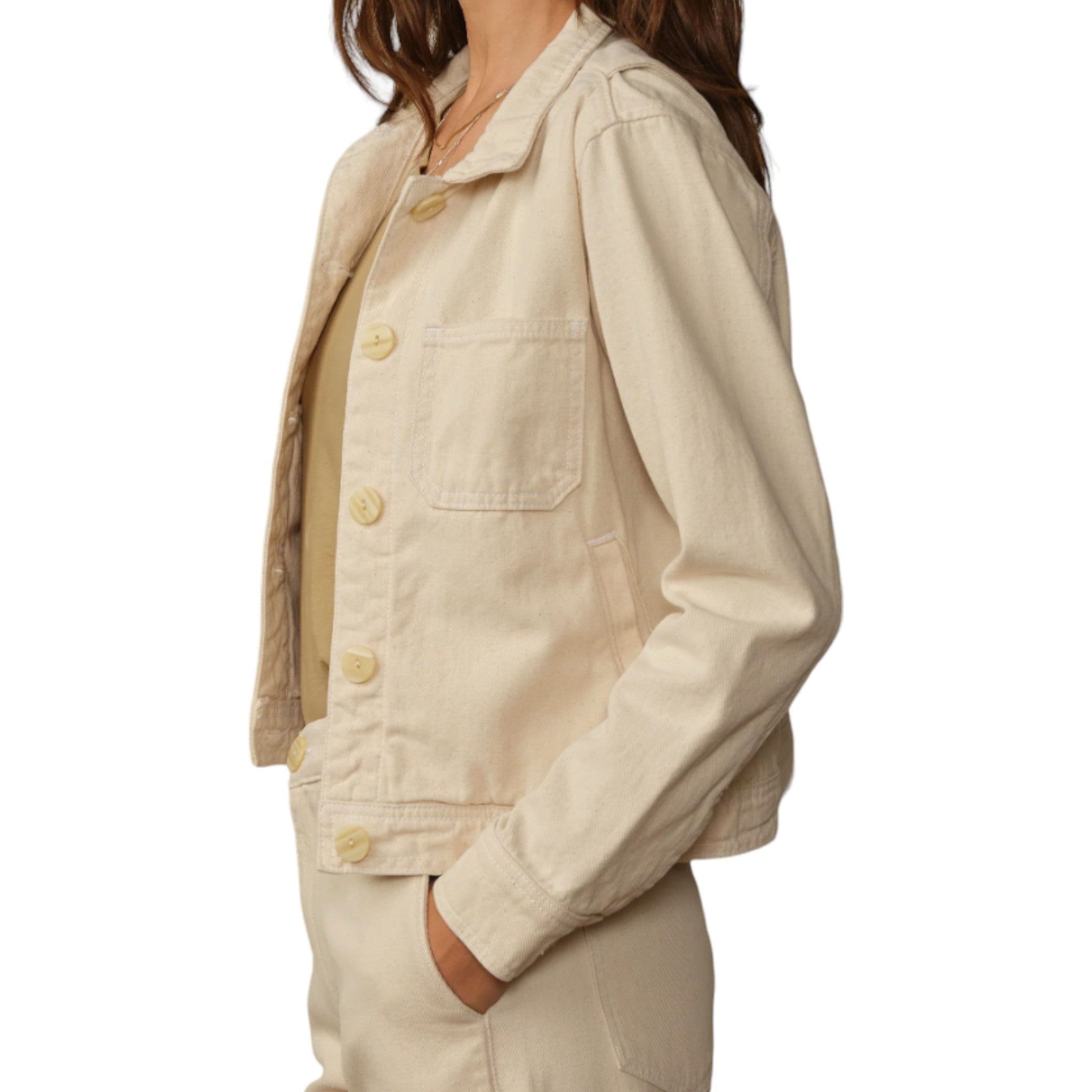 cream, denim style button up jacket with patch pockets on the chest and regular pockets with a cinching detail at the waist in the back