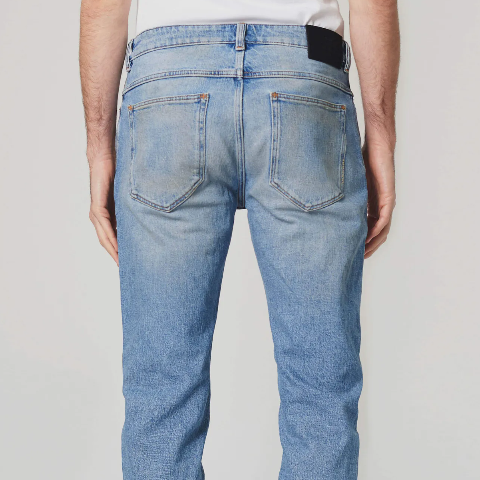 Light wash slim fit denim with button and zip closure