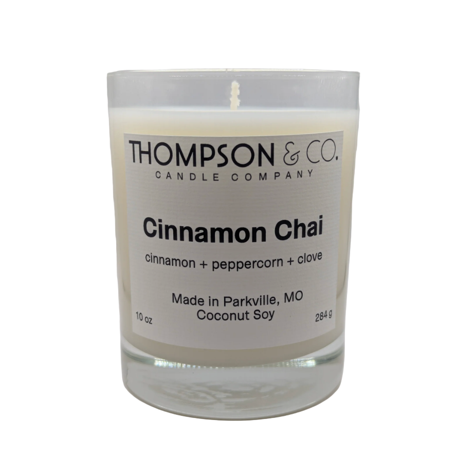 Candle with 'Thompson & Co.' label on a white background
