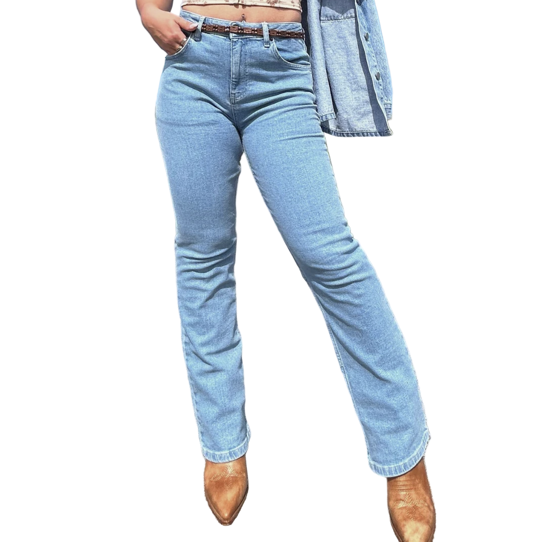 Person wearing light blue jeans and brown boots with a white background.
