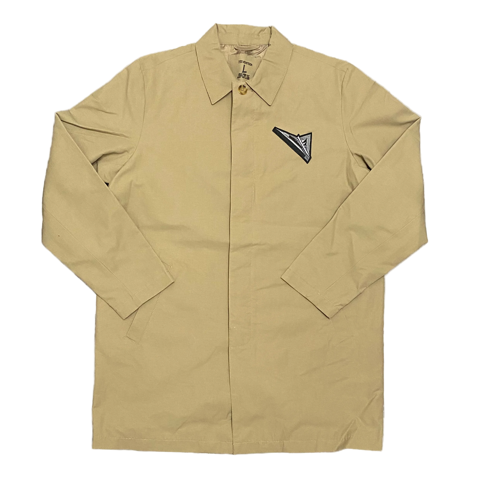 Beige jacket with a black and white triangle patch on a white background