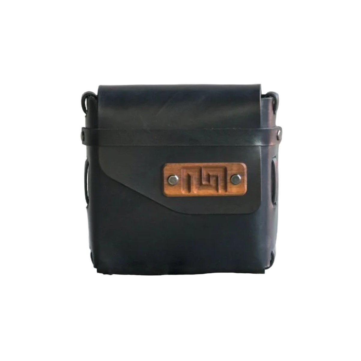 Black leather bag with a wooden clasp on a concrete surface