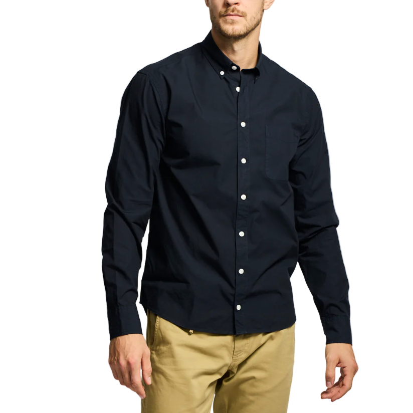 Man wearing a black button-up shirt and beige pants on a white background