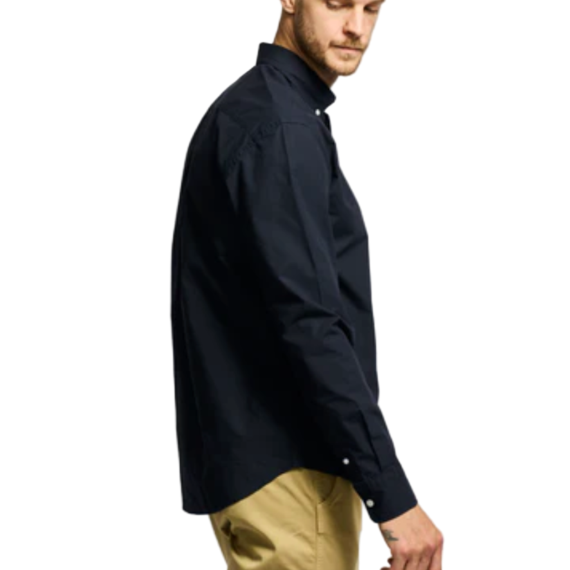 Man wearing a black shirt and beige pants on a white background