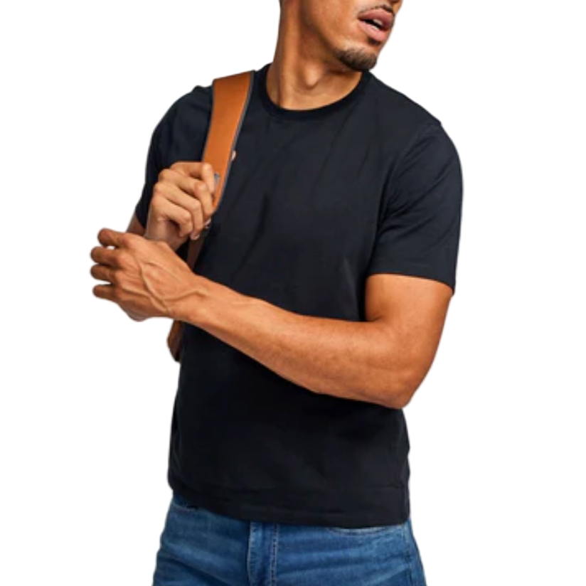 Man wearing a black t-shirt and blue jeans with a brown strap over his shoulder on a white background