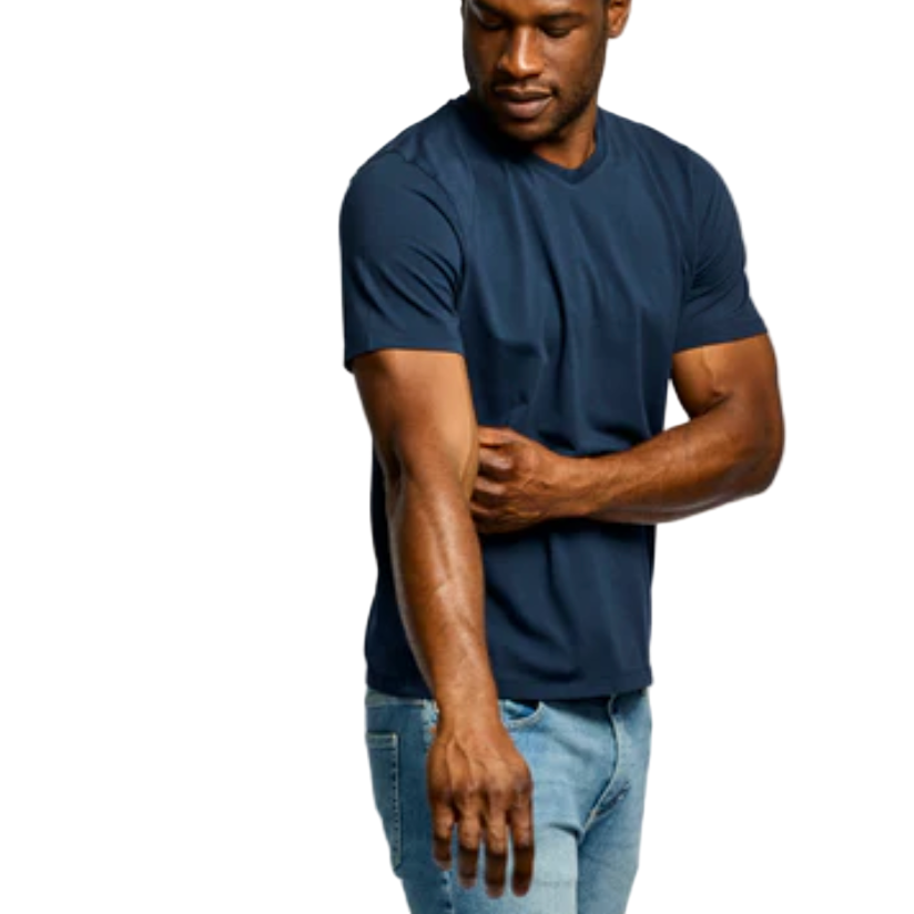 Man wearing a navy blue t-shirt and light blue jeans on a white background