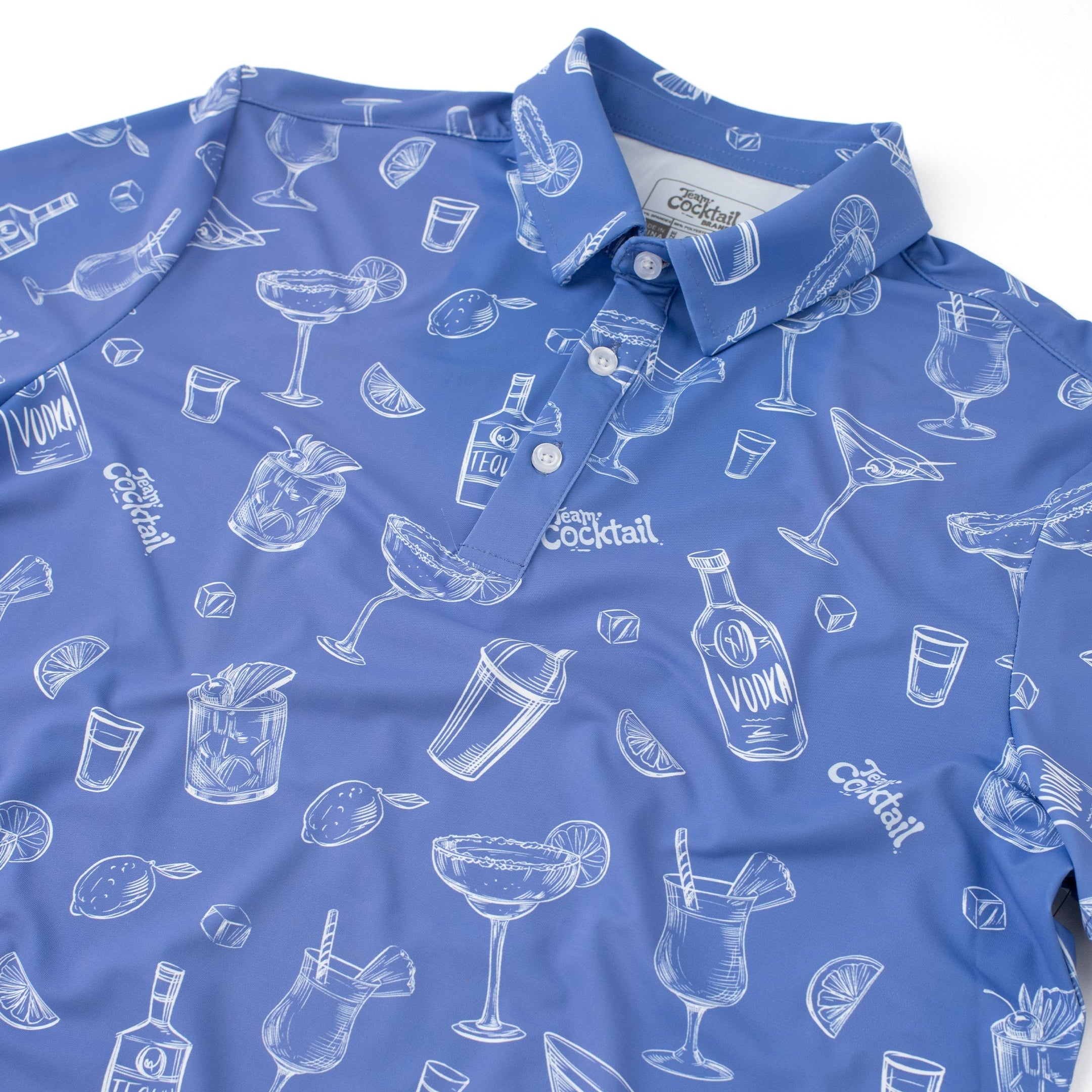 Blue polo shirt with white cocktail pattern on a white background
