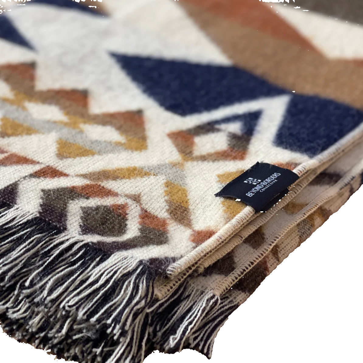 Patterned blanket with a brand tag on a wooden surface
