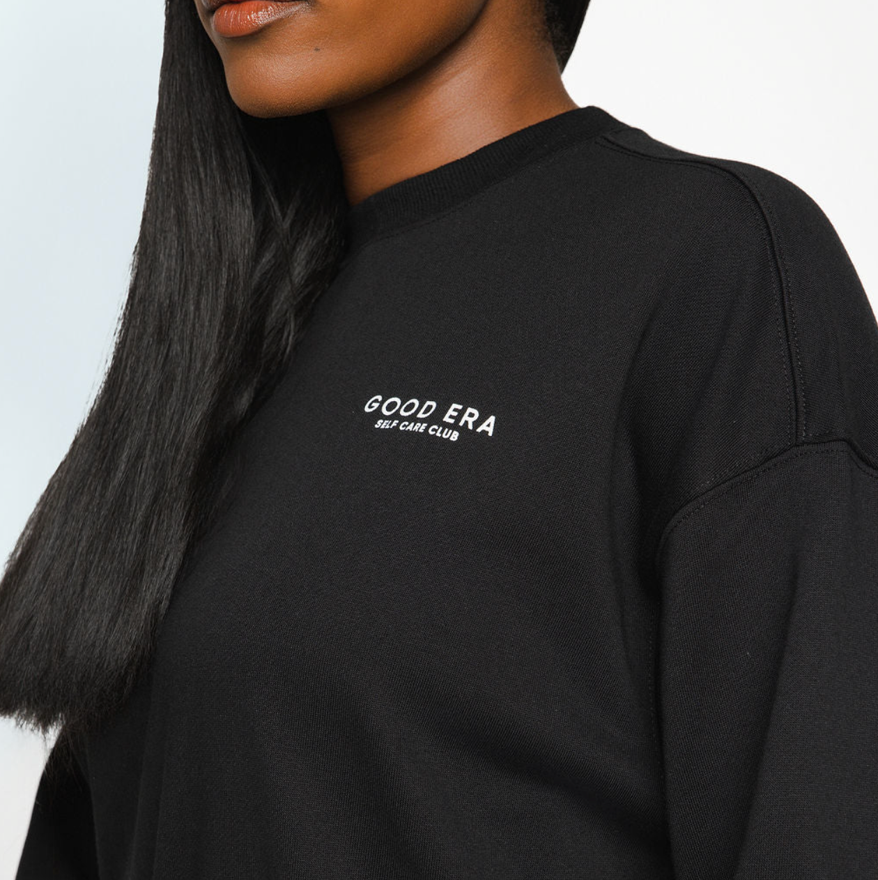 Black sweatshirt with 'GOOD ERA' text on a plain background