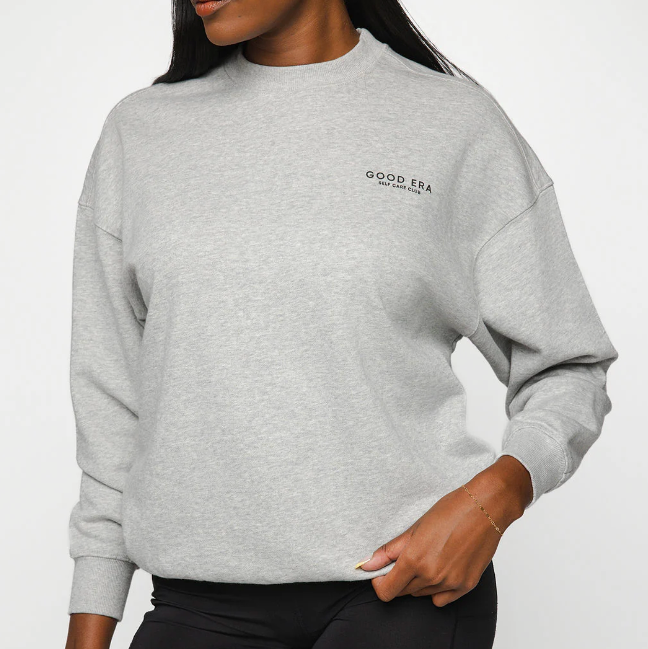 Person wearing a gray sweatshirt with 'Good Era' logo on a white background