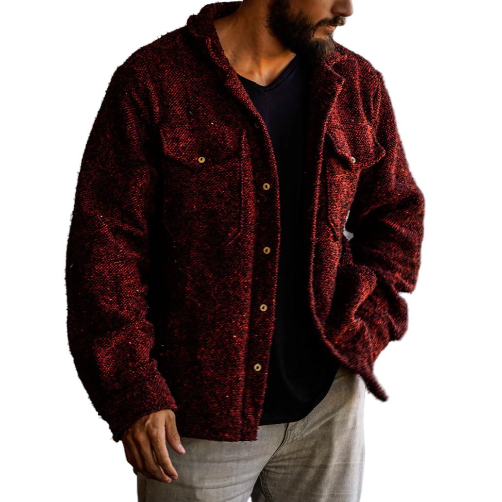 Man wearing a textured red-brown jacket against a white background