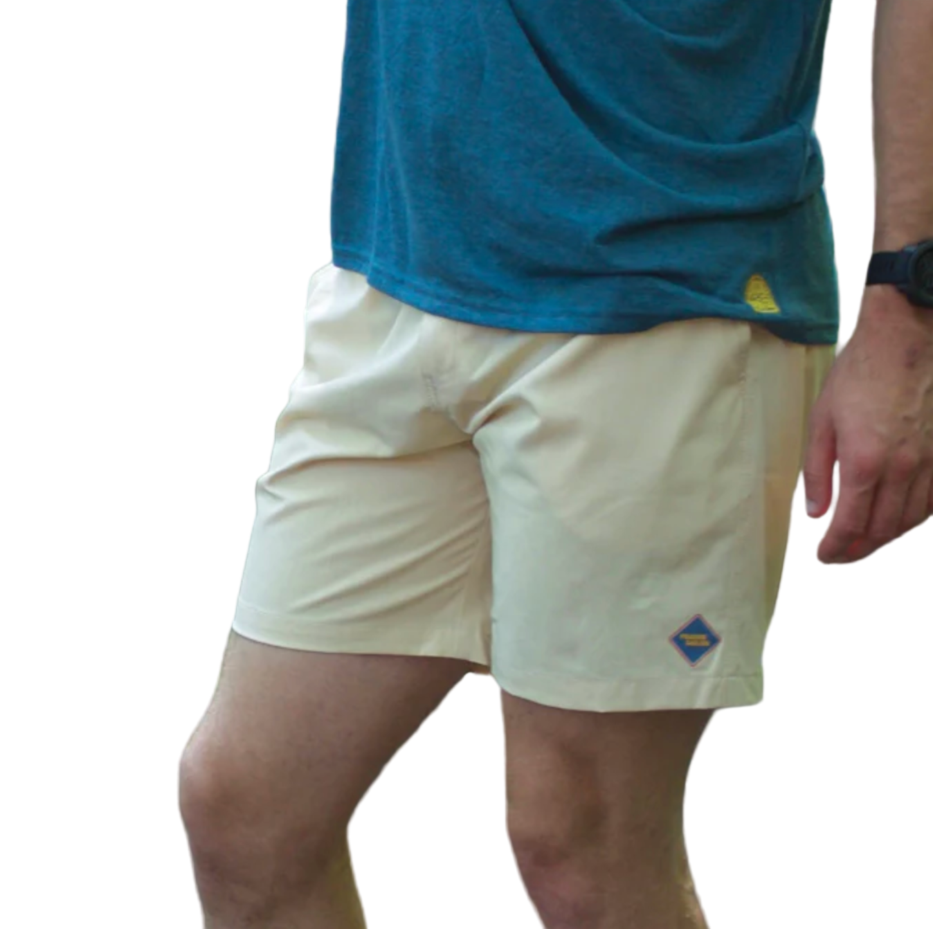 Person wearing beige shorts with a logo and a blue shirt outdoors.