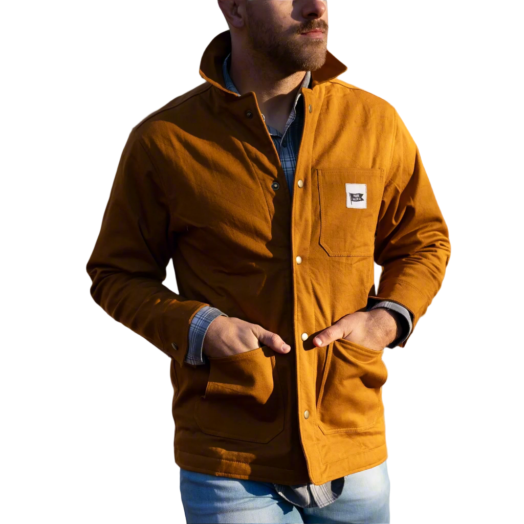Man wearing a brown jacket with a logo against a neutral background