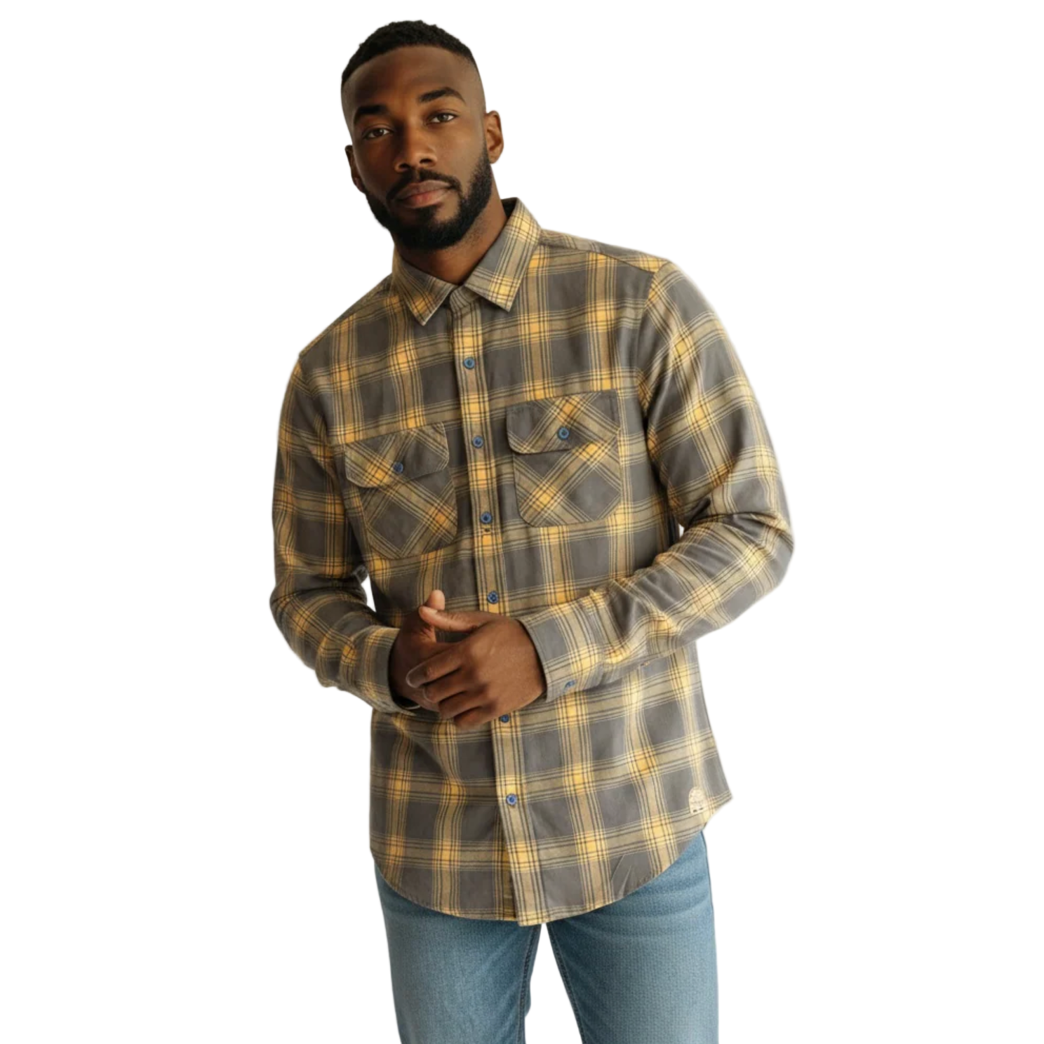 Man wearing a plaid shirt and jeans against a white background
