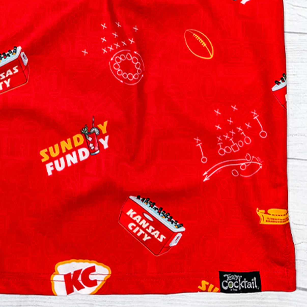 Red fabric with 'Sundy Fundy' and 'Kansas City' logos on a white background